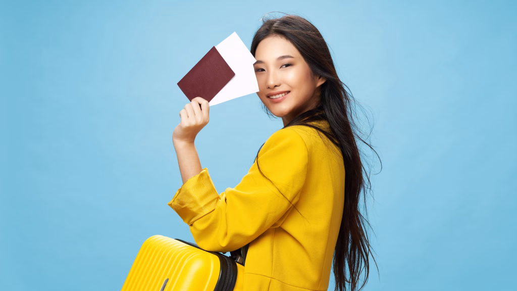 a female asian traveller holding her passport and luggage