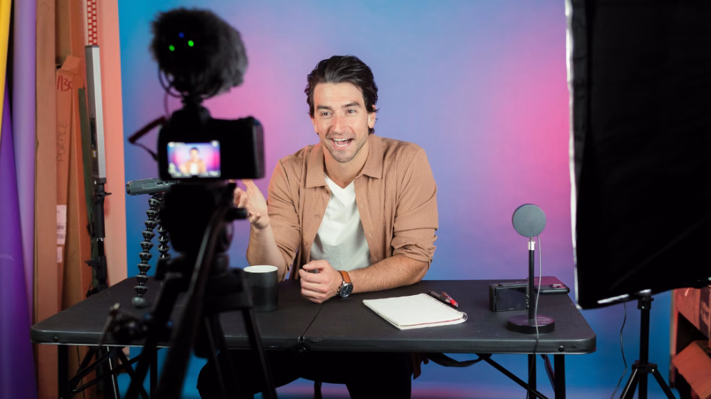 a global male influencer filming himself in his studio with a professional camera