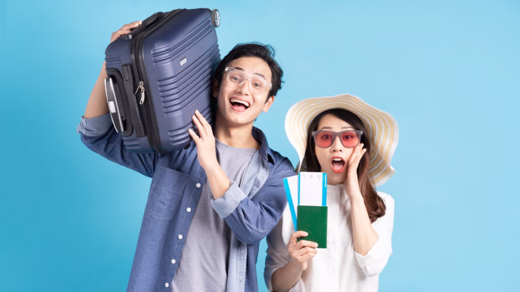 an asian couple showing off their luggage, passport and plane tickets