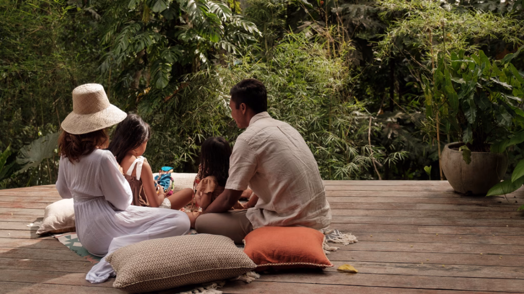 an asian family in a patio with two kids looking out the nature