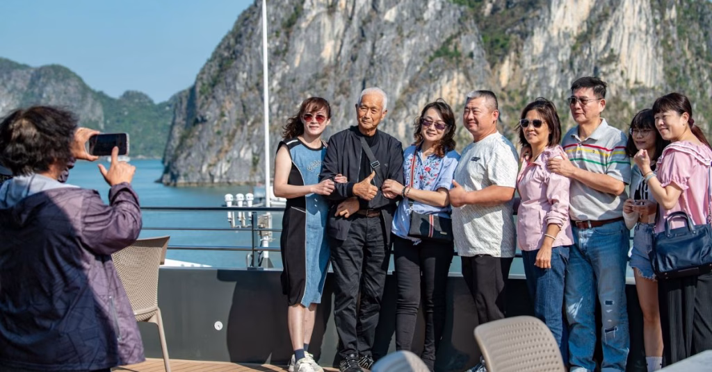 International tourists pose for a group photograph aboard a cruise boat in Vietnam. Photo Nam Tran Image Courtesy of Tuoi Tre